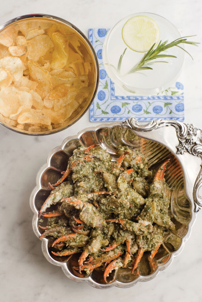 Overhead view of a bowl of crab claws and a bowl of potato chips