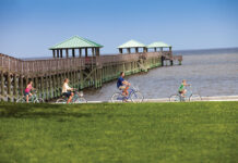 Family biking along the beach in Ocean Springs