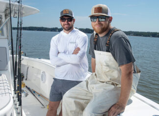 two men sitting on a fishing boat