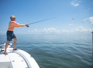 Man on a boat fishing for tripletail