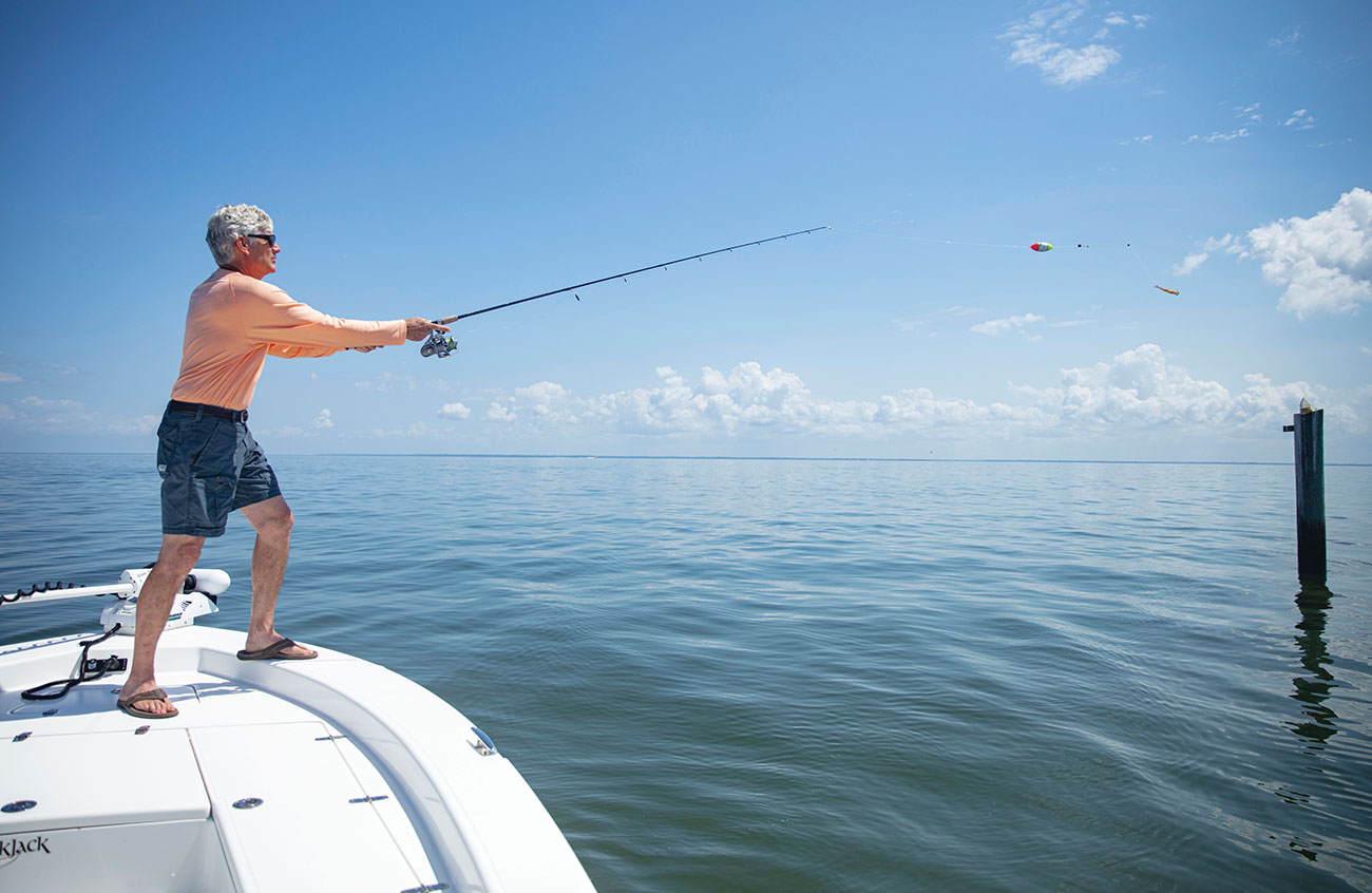 Man on a boat fishing for tripletail