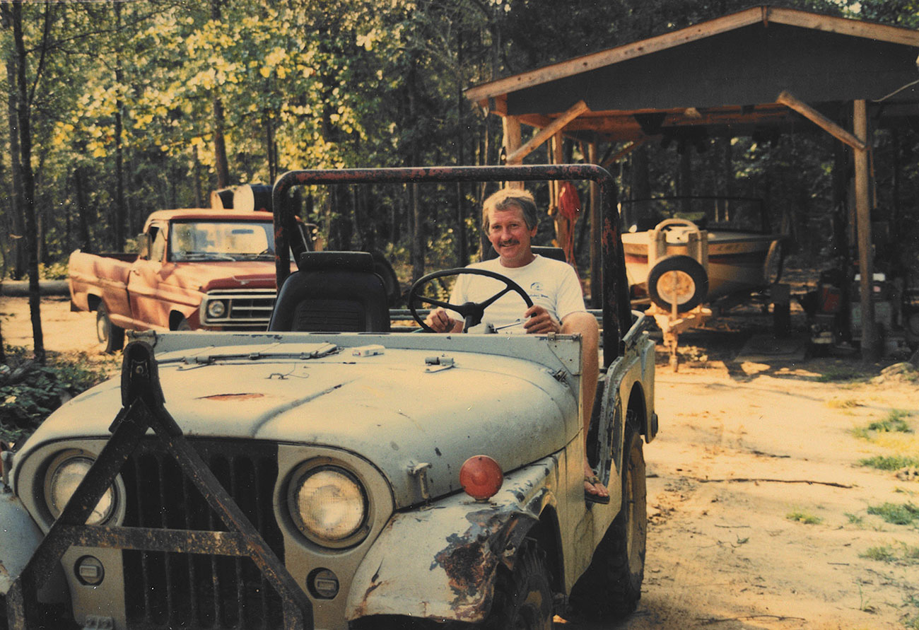 Man driving an open-top Jeep