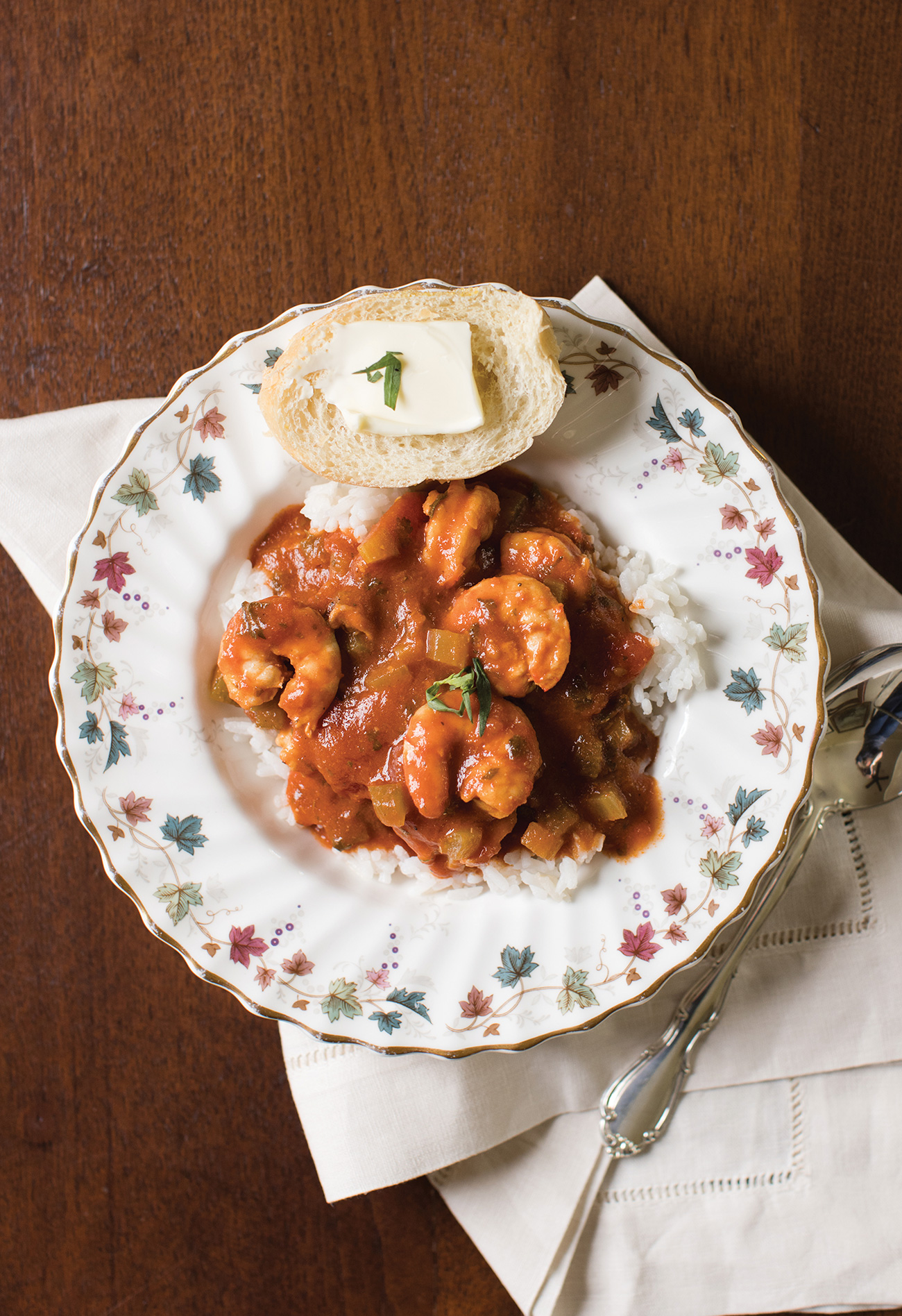Shrimp creole served over rice with a side of french bread on Royal Dalton Canterbury china.