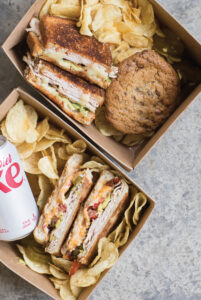 Boxes of sandwiches and chips