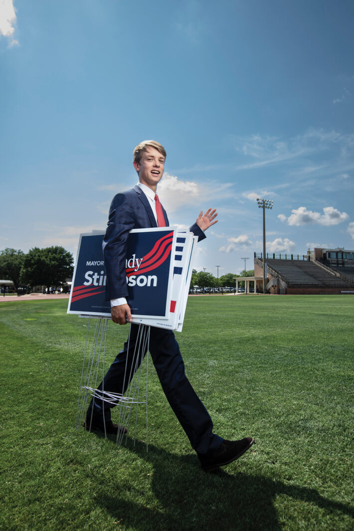 young man holding campaign posters 