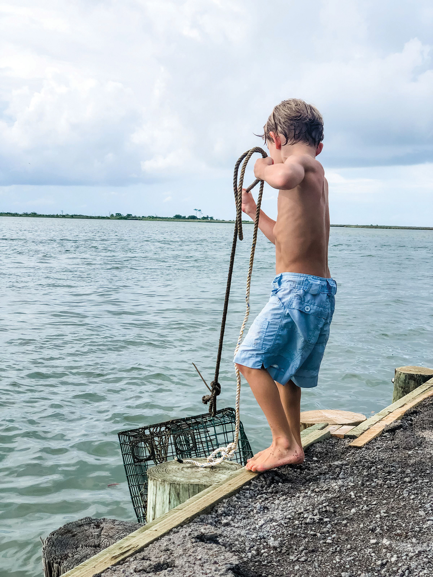 Little boy checking for crabs on Dauphin Island