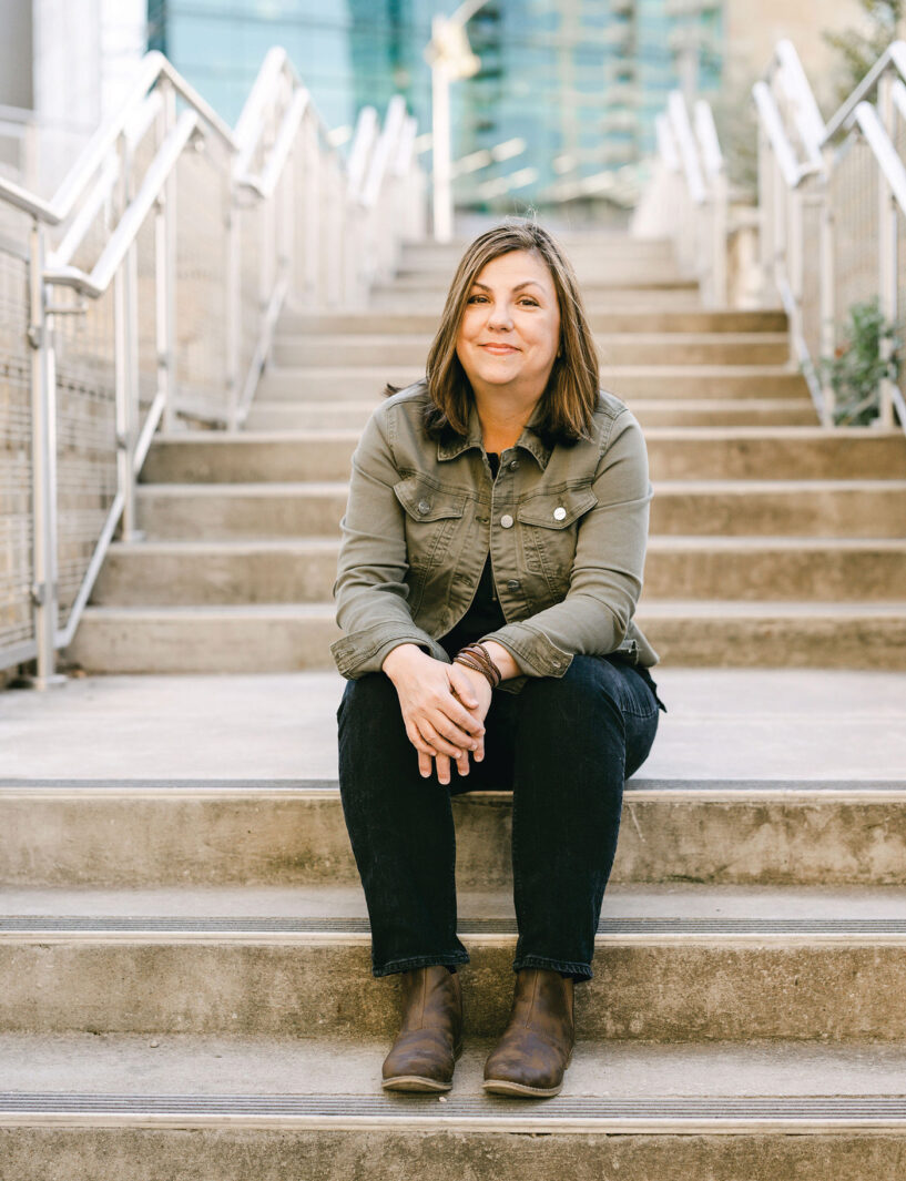 Mobile Author, Ramona Reeves sitting on the steps of a Mobile building 