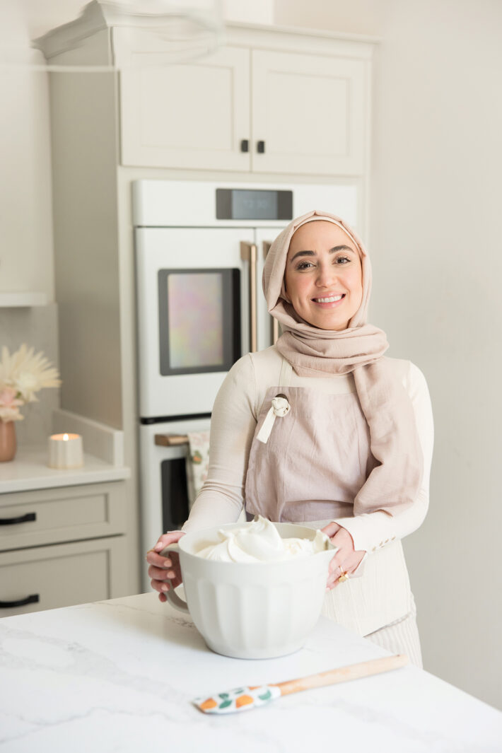 Nour Hasan holding homeade buttercream frosting 