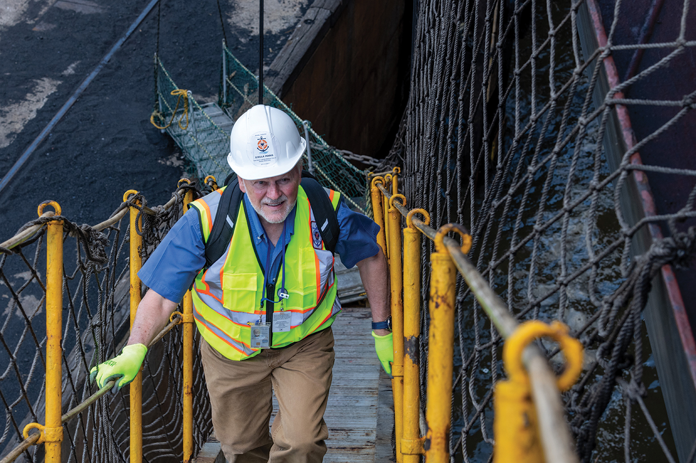 Deacon John Archer ascends the gangplank to greet the seafarers.