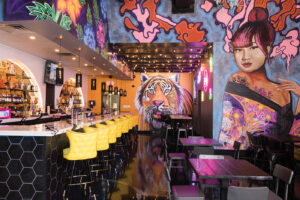 Interior of Vandals Street Kitchen. The walls are covered in bright street art and graffiti.