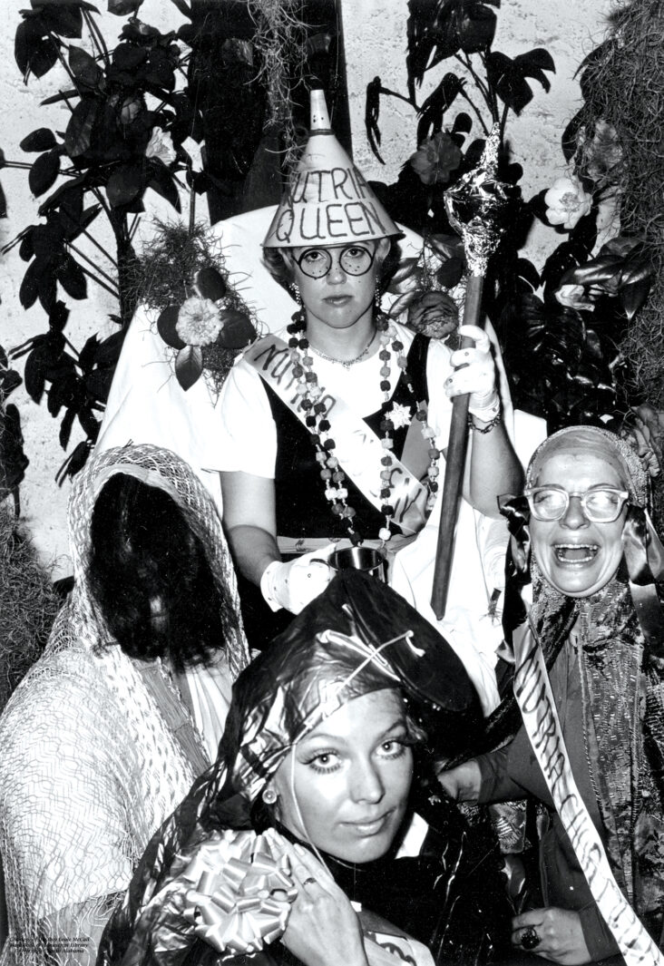 A black and white photo of the Nutria Queen in 1975 with a makeshift crown.