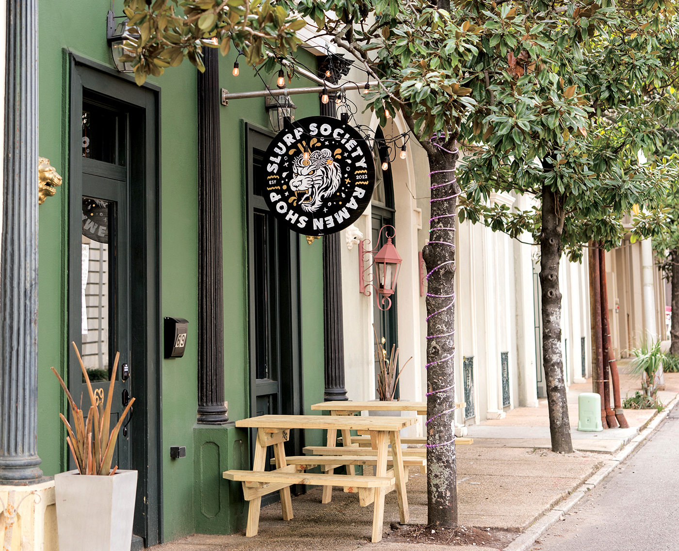 Exterior of the green building that Slurp Society Ramen Shop occupies on St. Michael Street in Mobile, AL. 