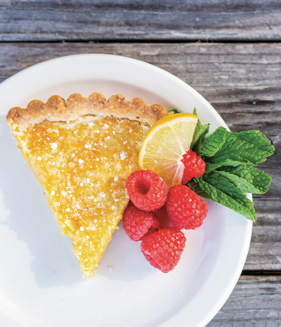 Shortbread Lemon Tart plated with fresh raspberries 