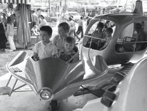 children on an airplane themed festival ride at the Greater Gulf State Fair