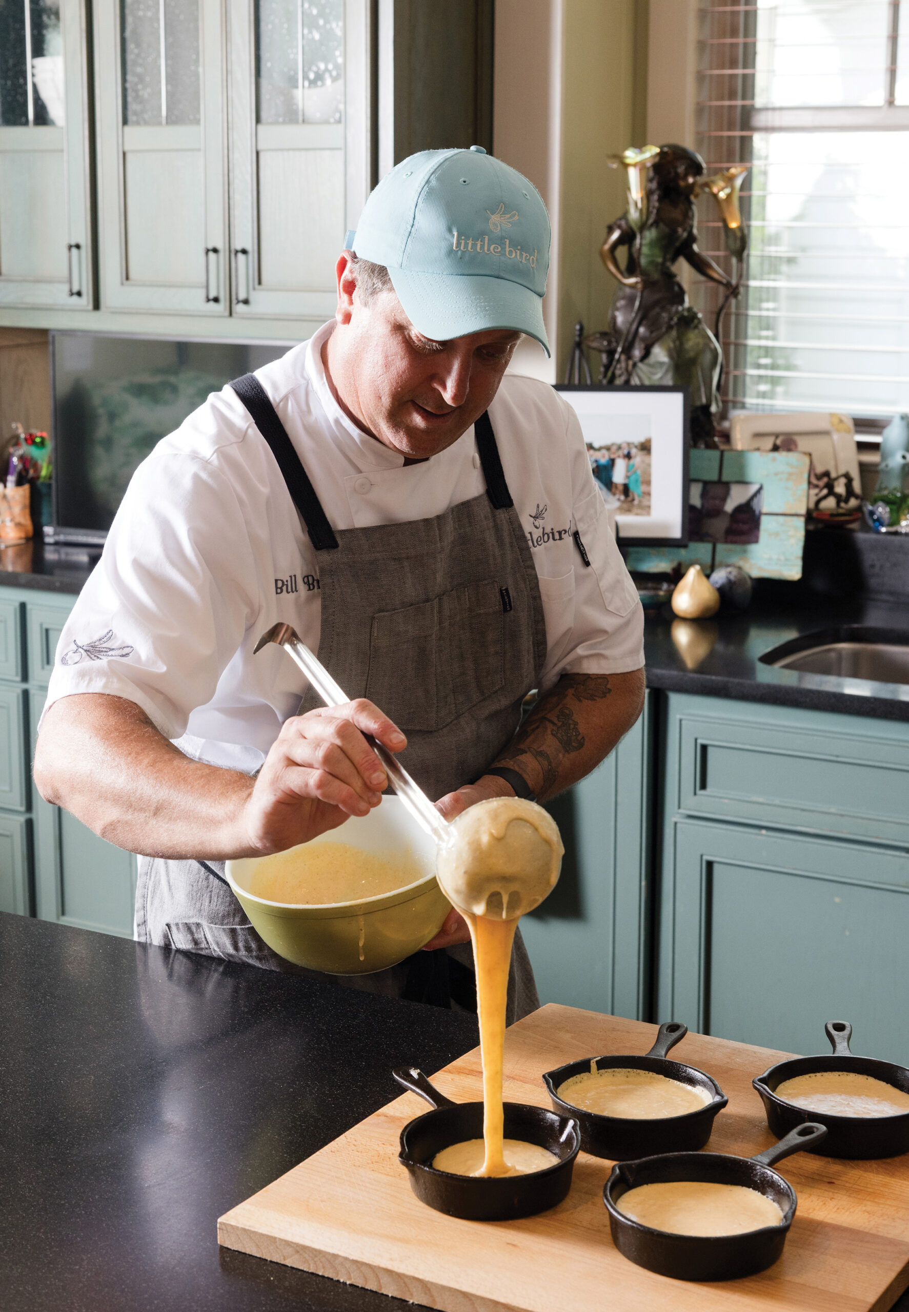 Bill Briand ladles cornbread batter into mini skillets