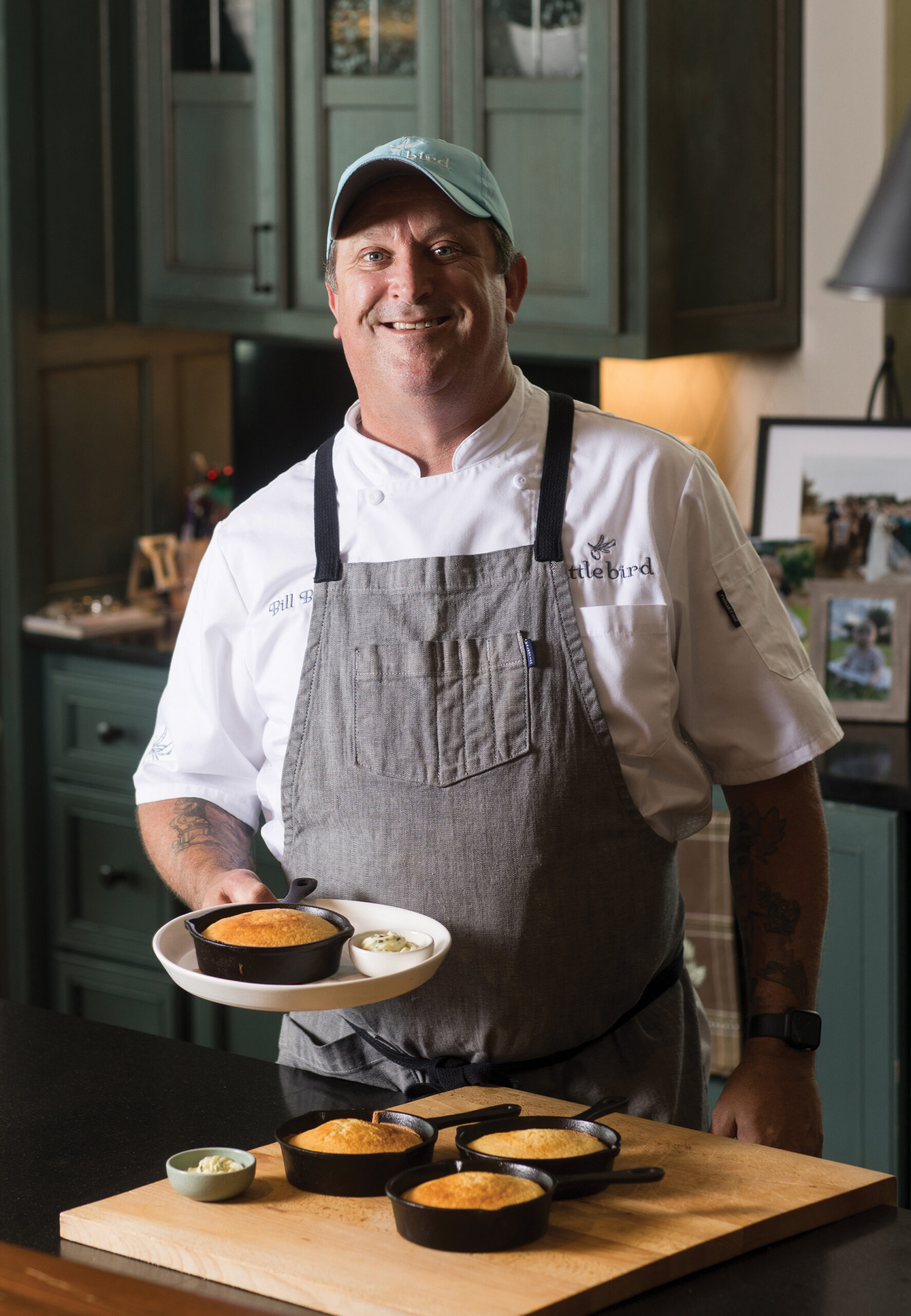 Portrait of Bill Briand holding a mini skillet of cornbread