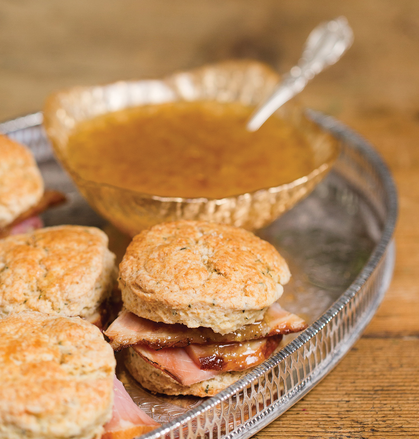 Ham on a scone with a bowl of jezebel sauce