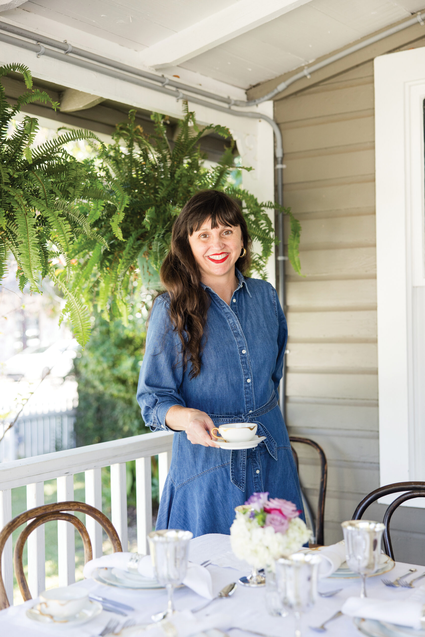 Portrait of Sally Stringfellow on the porch of her restaurant