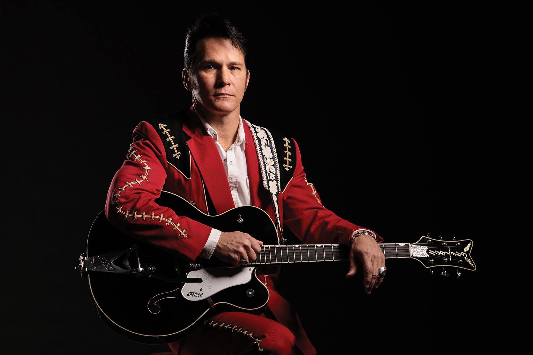 portrait of Gretsch Lyles holding his guitar