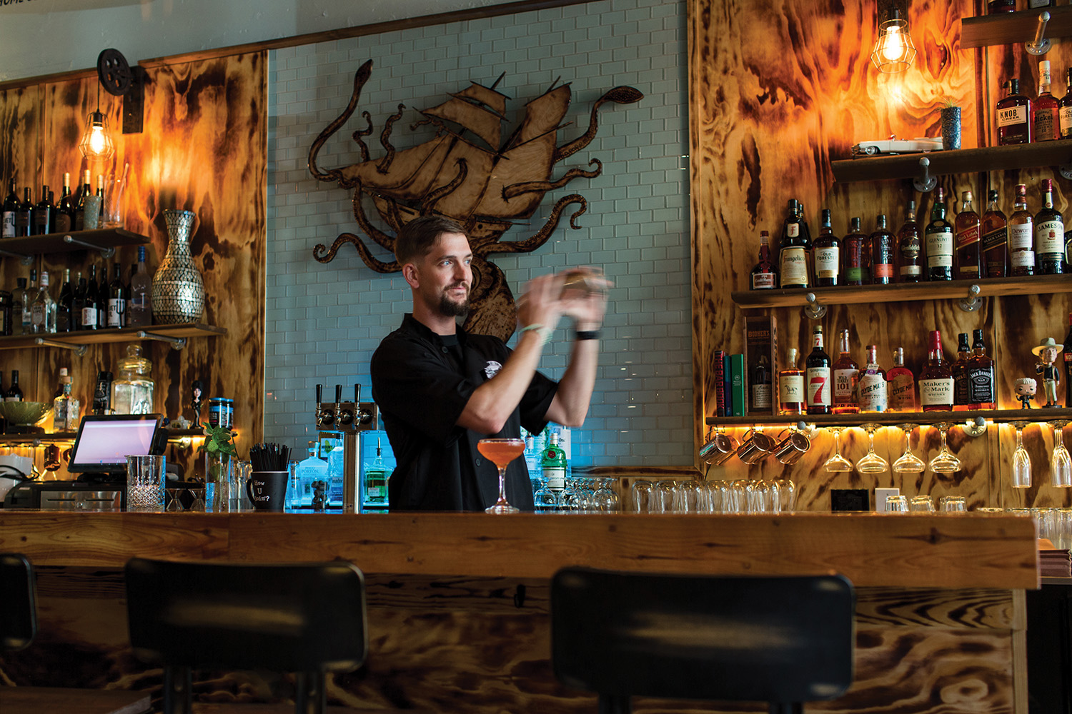 Bartender mixing drinks at Squid Ink