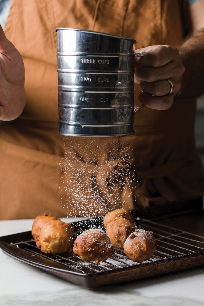 Apple fritters dusted with powdered sugar